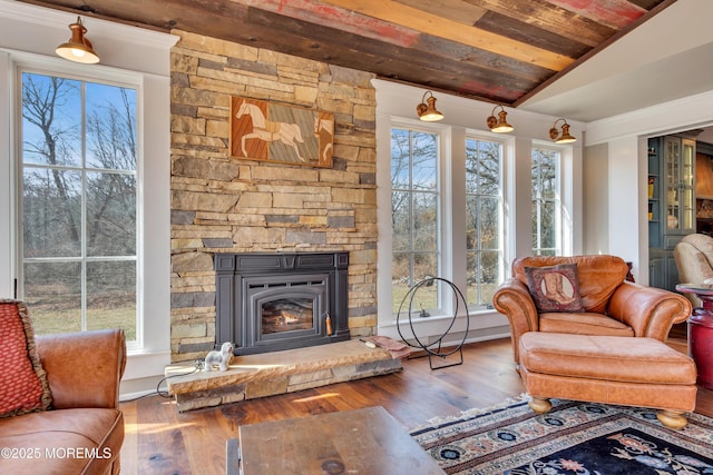 living area featuring a fireplace, lofted ceiling, and wood finished floors