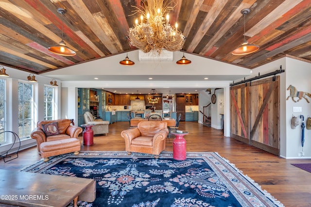 living area featuring wood ceiling, a barn door, vaulted ceiling, wood finished floors, and a notable chandelier