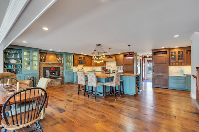 dining area with a fireplace, dark wood-type flooring, and recessed lighting