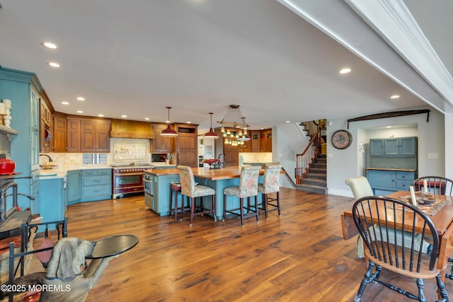 dining room with dark wood-type flooring, stairway, recessed lighting, and baseboards