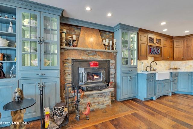 interior space with recessed lighting, wood finished floors, light countertops, and a sink