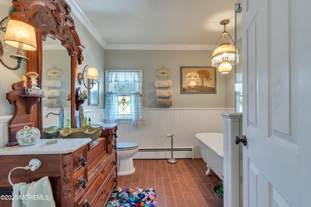 full bath with a baseboard heating unit, a wainscoted wall, toilet, a soaking tub, and vanity