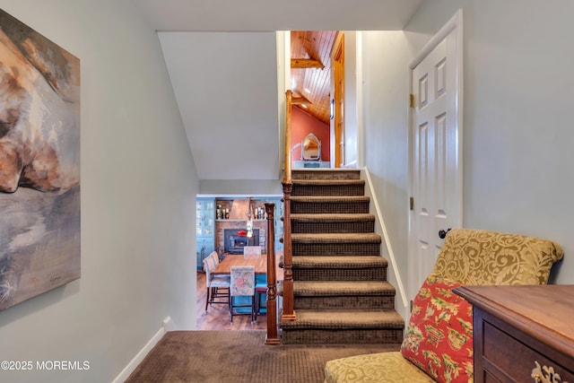 stairs with baseboards and vaulted ceiling