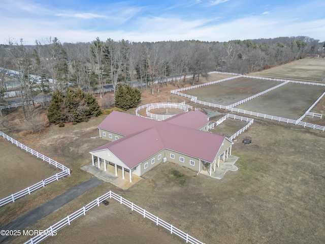 aerial view featuring a rural view and a wooded view