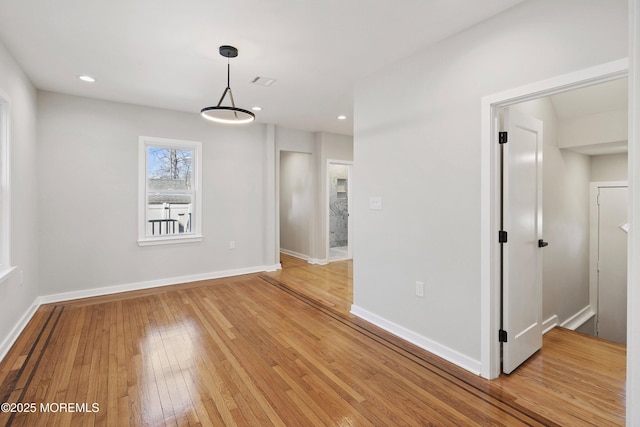 unfurnished dining area with recessed lighting, light wood-style flooring, visible vents, and baseboards