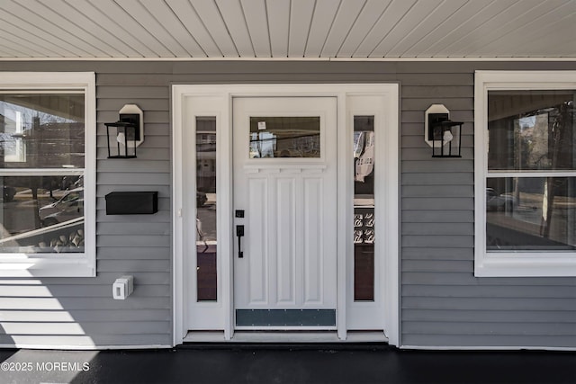 view of exterior entry with covered porch