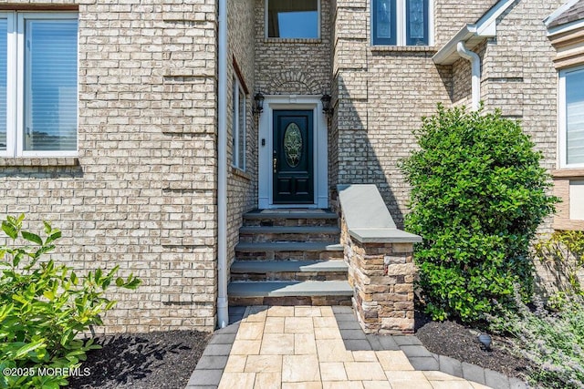 property entrance with brick siding