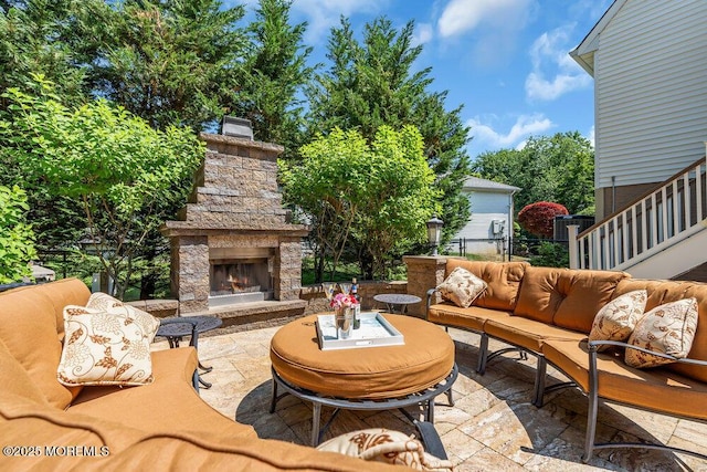 view of patio / terrace featuring fence and an outdoor living space with a fireplace