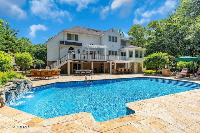 pool featuring outdoor dining area, a pergola, stairs, a deck, and a patio area