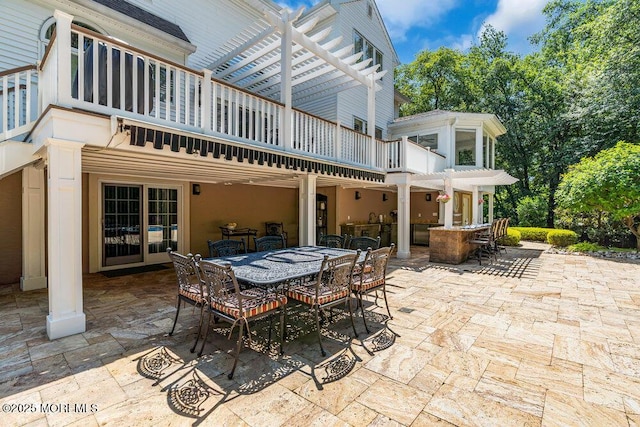 view of patio / terrace with outdoor dining space, a pergola, and a balcony