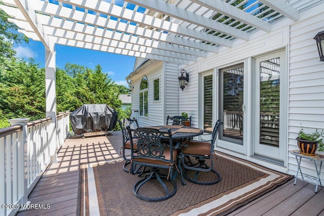 wooden deck with outdoor dining space, area for grilling, and a pergola