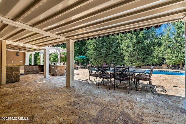 view of patio / terrace with an outdoor pool, outdoor dining area, outdoor dry bar, and a pergola