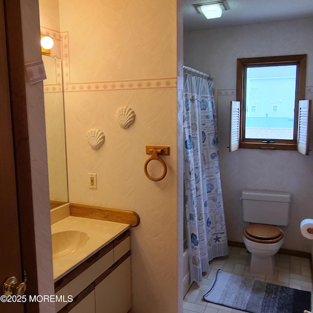 bathroom featuring vanity, toilet, and shower / tub combo with curtain