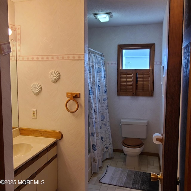 bathroom with vanity, visible vents, shower / bath combo, tile patterned flooring, and toilet