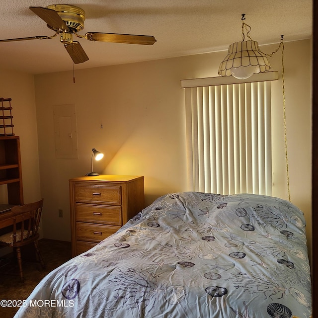 bedroom with electric panel and a ceiling fan