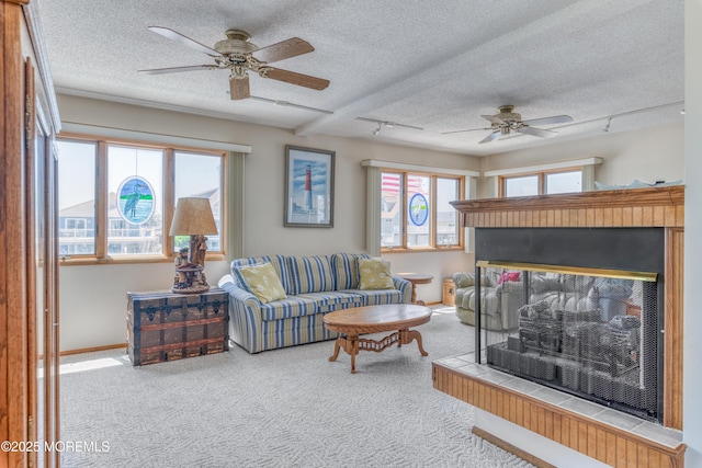 35 W Mohawk Dr, Little Egg Harbor, NJ 08087 - carpeted living room featuring a textured ceiling, ceiling fan, a multi sided fireplace, and baseboards