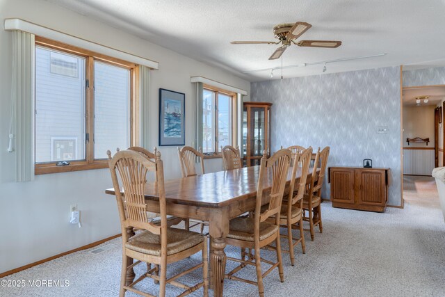 35 W Mohawk Dr, Little Egg Harbor, NJ 08087 - dining space with wallpapered walls, light colored carpet, ceiling fan, baseboards, and track lighting