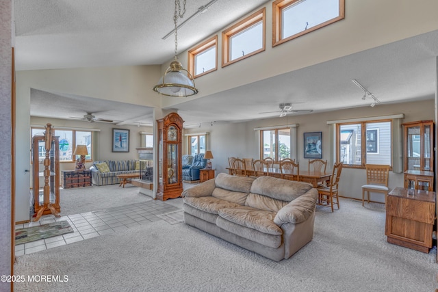35 W Mohawk Dr, Little Egg Harbor, NJ 08087 - carpeted living room with rail lighting, a textured ceiling, a ceiling fan, and tile patterned floors