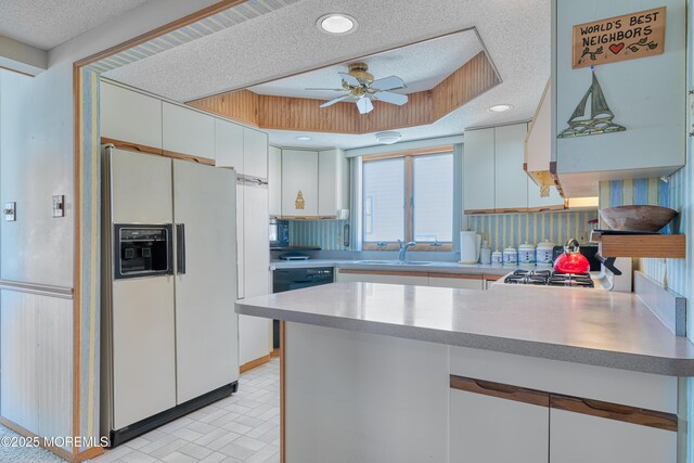 35 W Mohawk Dr, Little Egg Harbor, NJ 08087 - kitchen featuring white refrigerator with ice dispenser, a sink, a peninsula, a ceiling fan, and white cabinets