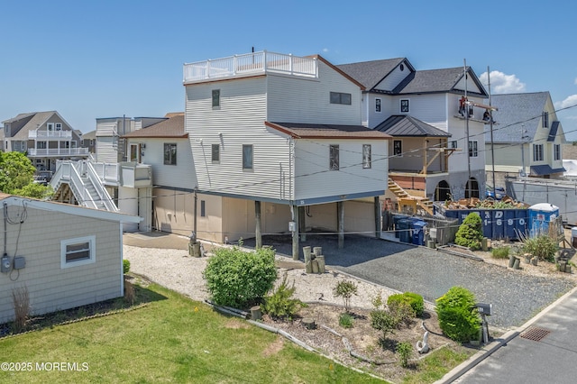 35 W Mohawk Dr, Little Egg Harbor, NJ 08087 - back of house with a residential view, gravel driveway, an attached garage, stairway, and roof with shingles