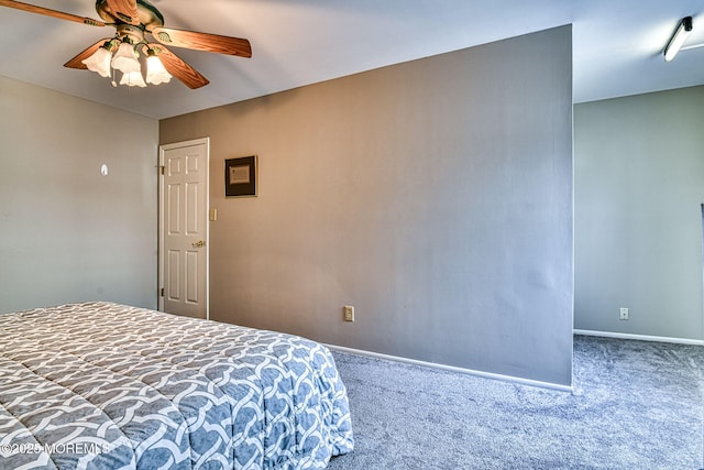 carpeted bedroom featuring a ceiling fan and baseboards