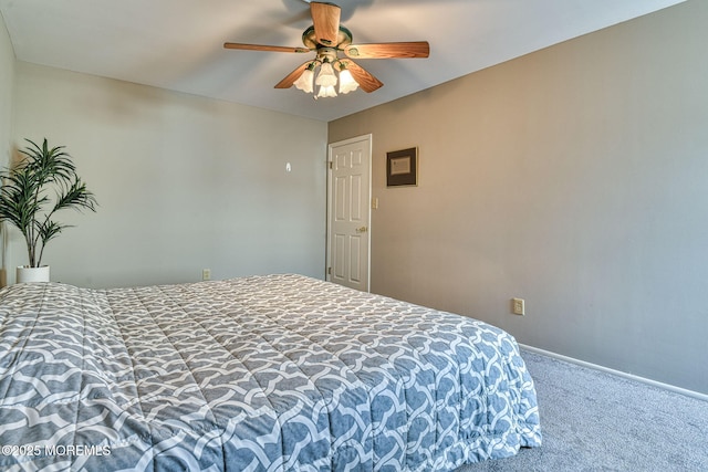 bedroom featuring a ceiling fan, carpet, and baseboards