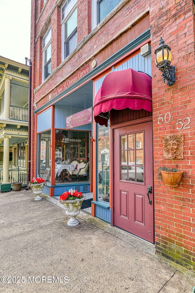 property entrance featuring brick siding