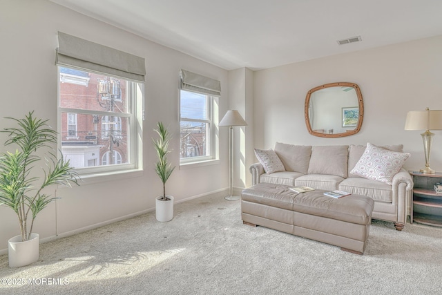 living room with baseboards, visible vents, and carpet floors