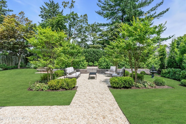 view of yard with a patio, outdoor lounge area, and fence