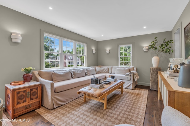 living room featuring dark wood-type flooring, recessed lighting, and baseboards