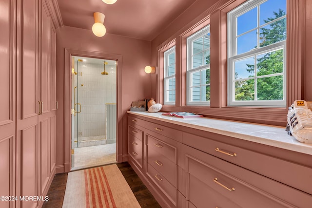 full bath featuring a shower stall, vanity, and wood finished floors