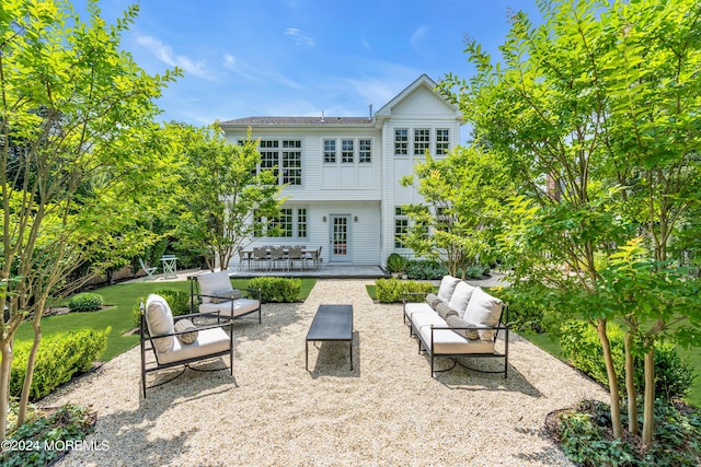 rear view of property featuring a patio, a lawn, and an outdoor hangout area