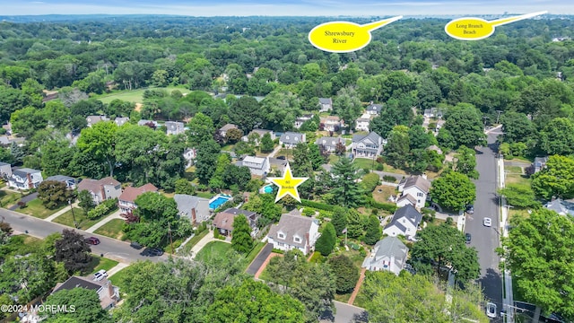 bird's eye view featuring a wooded view and a residential view