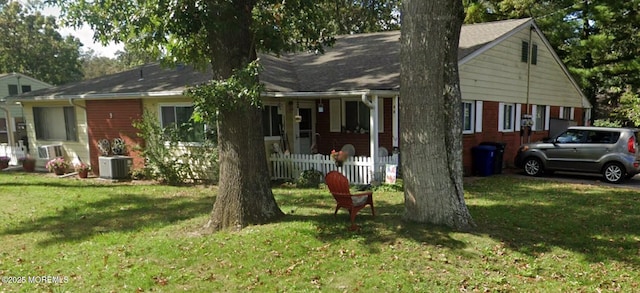 exterior space with a yard, fence, and central AC