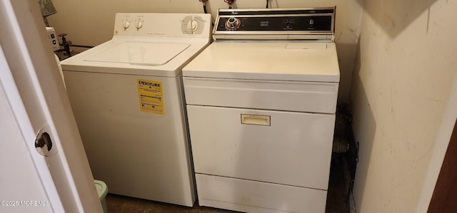 clothes washing area featuring washer and dryer and laundry area