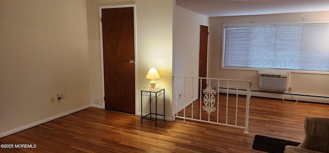 interior space featuring wood finished floors, baseboards, and a baseboard radiator