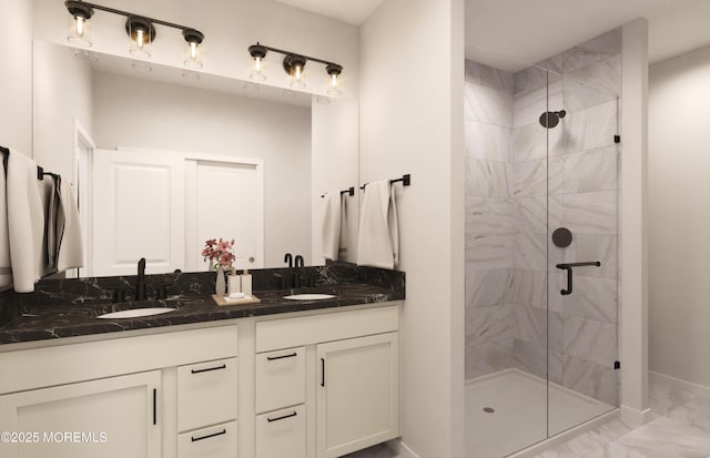 bathroom featuring a sink, double vanity, and a shower stall