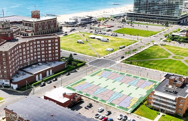 drone / aerial view featuring a beach view and a water view