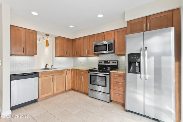 5 Island View Way Unit 3, Sea Bright, NJ 07760 - kitchen with stainless steel appliances, a sink, backsplash, brown cabinets, and recessed lighting