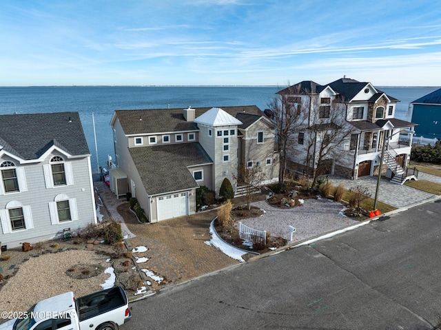 birds eye view of property featuring a residential view and a water view