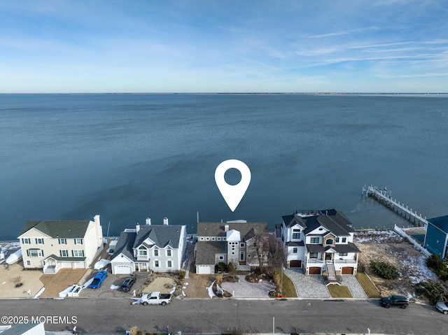 birds eye view of property with a residential view and a water view