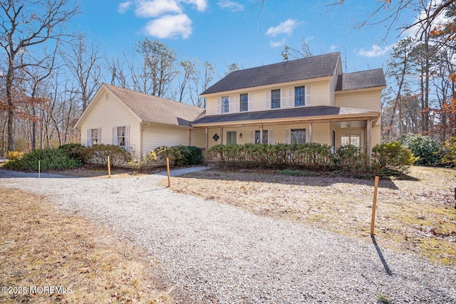 view of front of home featuring covered porch and a shingled roof