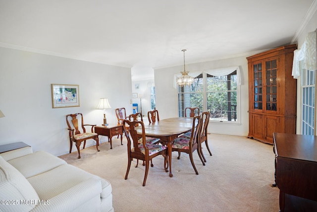 dining space with light carpet, a notable chandelier, and crown molding