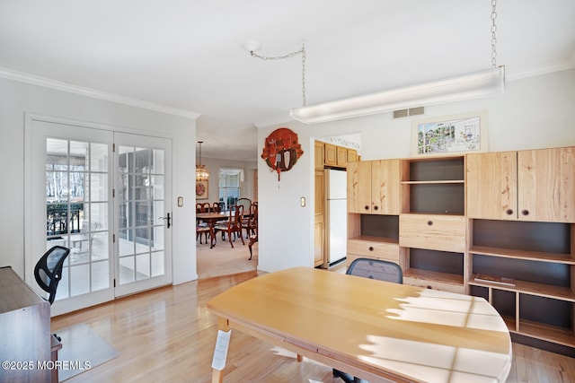 office featuring visible vents, light wood-style floors, and ornamental molding