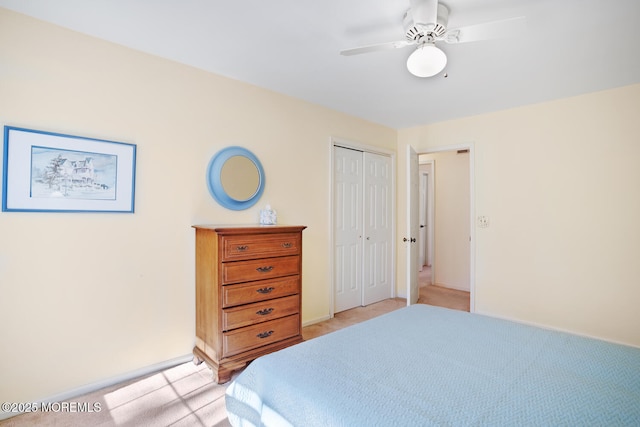 bedroom featuring light carpet, a closet, and ceiling fan