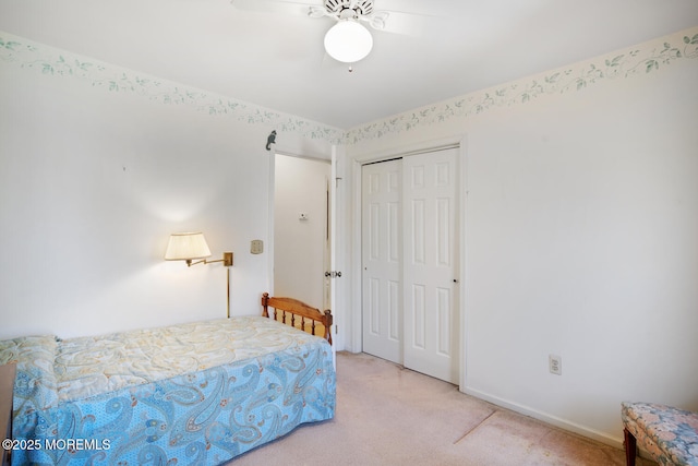 bedroom featuring a closet, baseboards, carpet, and a ceiling fan