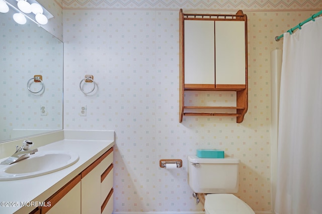 full bathroom featuring wallpapered walls, toilet, and vanity