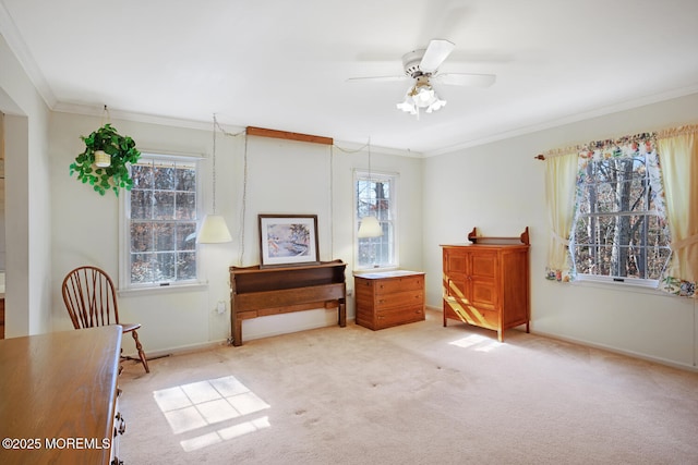 sitting room with crown molding, a ceiling fan, baseboards, and carpet floors