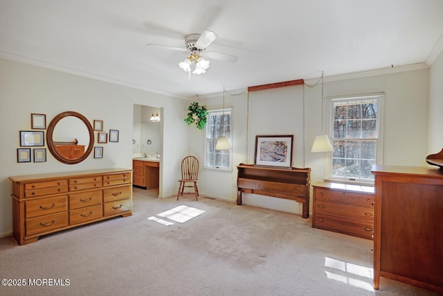 bedroom with crown molding, baseboards, ceiling fan, light colored carpet, and ensuite bathroom