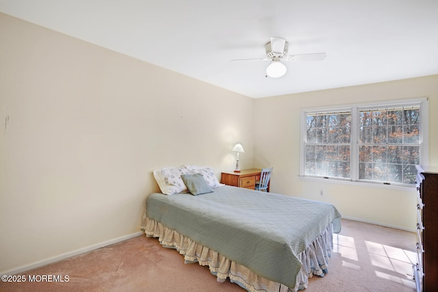 bedroom with light carpet, ceiling fan, and baseboards